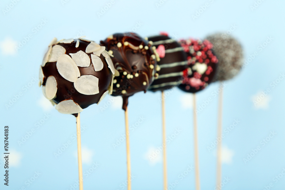 Tasty cake pops on blue background