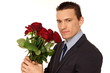 © petrdlouhy - Young man in suit holding flowers of roses