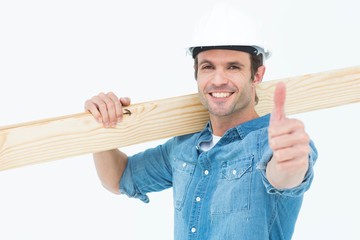 Poster - Confident carpenter carrying wooden plank