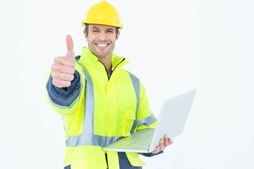 Poster - Architect in reflective clothing with laptop gesturing thumbs up