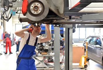 Wall Mural - Automechaniker // Mechanic checks a vehicle