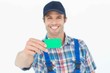 © WavebreakMediaMicro - Happy plumber showing green card
