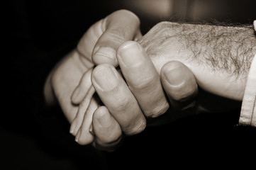 Wall Mural - young man holding the hand of an old man, in black and white