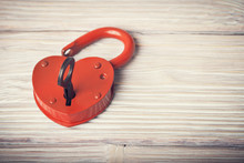 Open Heart Shaped Lock And Key Over Light Vintage Wooden Backgro