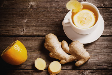 Wall Mural - Ginger tea with lemon in a white cup