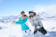 © goodluz - Couple in snowy mountain doing snowballs fight