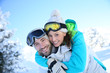 © goodluz - Man giving piggyback ride to girlfriend in snowy mountain