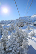 © goodluz - Back view of skiers in chairlift in snowy mountain