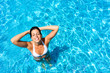 © Dirima - Woman having fun and relaxing in swimming pool