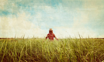 Poster - Hipster girl walking on summer meadow, vintage image