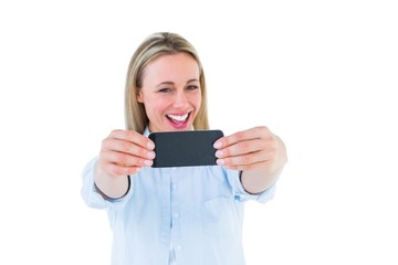 Poster - Happy blonde taking a selfie with smartphone