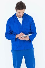 Poster - Mechanic using digital tablet over white background