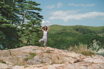 Wall Mural - Traveler woman standing in yoga pose of tree