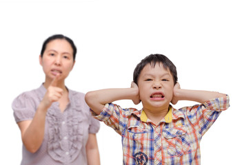 young asian boy being scolded by his mother