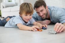 Daddy With Little Boy Playing With Toy Cars