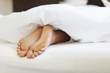© gpointstudio - Close up of female feet in bed