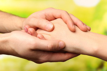 Wall Mural - Male and female hands on bright background