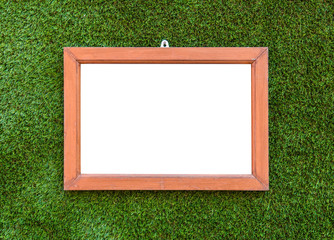 Empty Wooden photo frame hang on Artificial Green grass backgrou