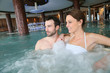 © goodluz - Couple enjoying bath in spa center jacuzzi