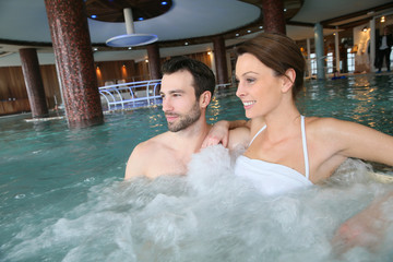 Wall Mural - Couple enjoying bath in spa center jacuzzi