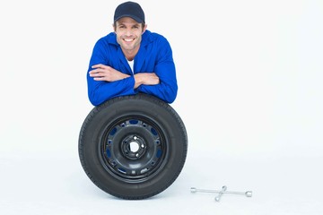 Poster - Handsome mechanic leaning on tire