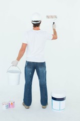 Aufkleber - Rear view of man using paint roller