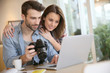 © goodluz - Couple watching photos on laptop computer