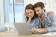 © goodluz - Couple at home websurfing on internet