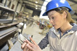 © goodluz - Woman engineer in steel plant checking production