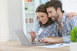 © goodluz - Couple at home websurfing on internet