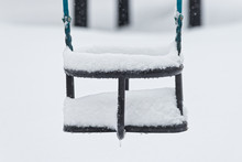 Snow Covered Swing During Winter