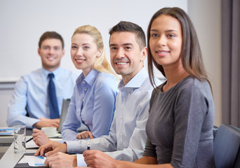 Canvas Print - group of smiling businesspeople meeting in office