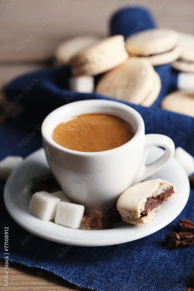 Gentle colorful macaroons and  coffee in mug