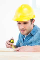 Poster - Carpenter measuring wood plank