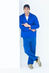 Poster - Confident mechanic pointing at bill board