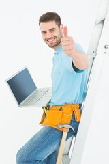 Poster - Construciton worker gesturing thumbs up while leaning on ladder