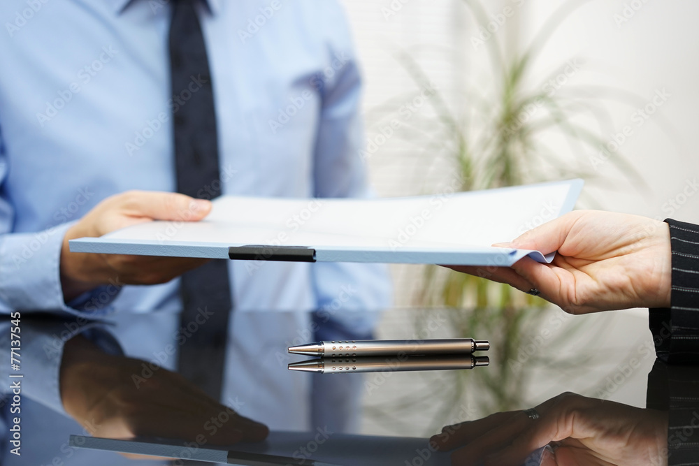 businessman is passing signed agreement to client after successf