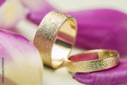 Fototapeta na wymiar Two stylish textured gold wedding rings