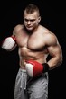 © Nejron Photo - Muscular young man wearing boxing gloves