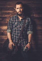 Wall Mural - Man wearing checkered shirt in wooden rural house