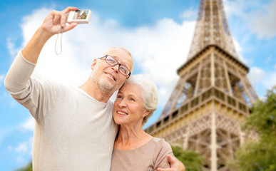 Poster - senior couple with camera over eiffel tower