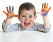 little boy with paints on hands