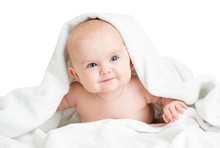 Cute Smiling Baby Girl Lying Under Towel After Bathing