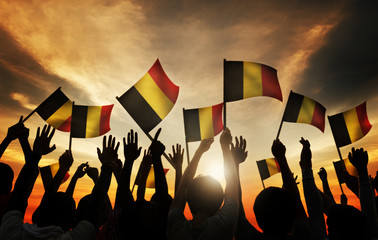 Canvas Print - Group People Waving Belgian Flags Back Lit Concept