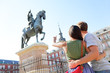 Madrid tourists on Plaza Mayor looking at statue
