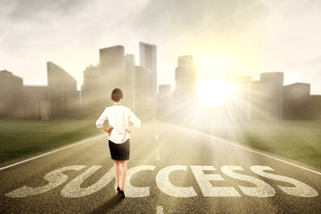 Businesswoman standing on the success way