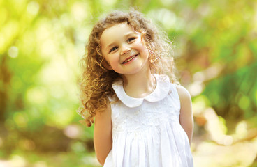 Wall Mural - Cute child shone with happiness, curly hair, charming smile