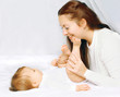 © rohappy - Happy moment mother playing with baby in bed home