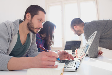 Young group of architects discussing business plans.