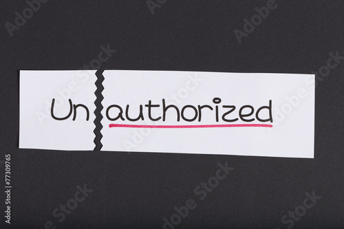Fotografie, Obraz Sign with word unauthorized turned into authorized